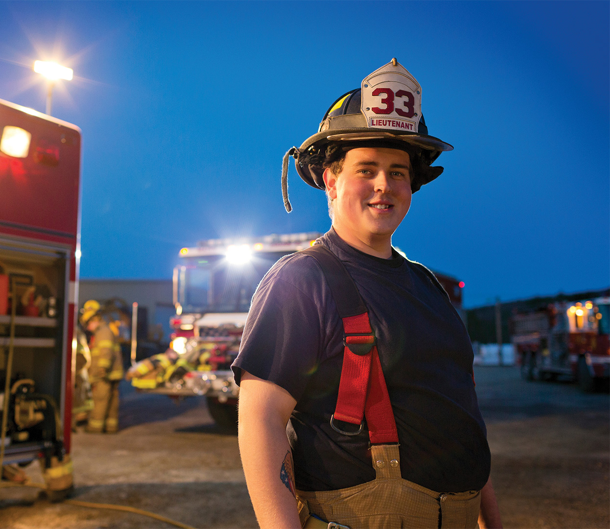 Firefighter beside a fire truck
