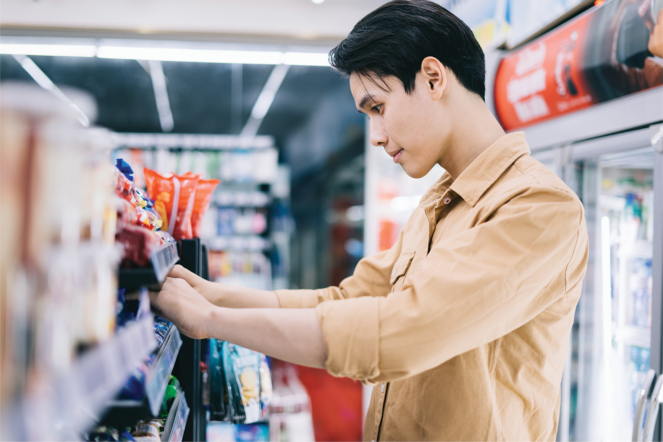 Shopper reaching for items on a shelf